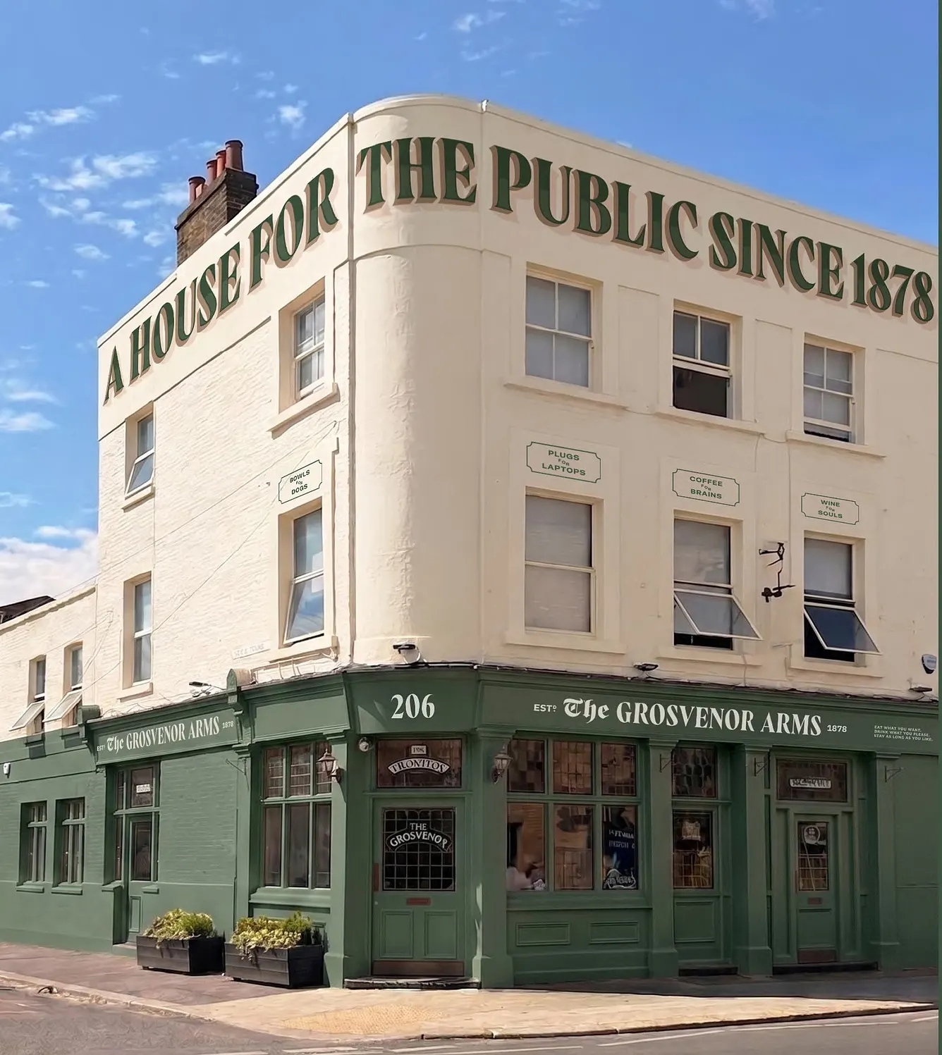 The Grosvenor Arms on the corner of Garratt Lane in Earlsfield, with "A House for the Public since 1878" painted in green across the top of the building