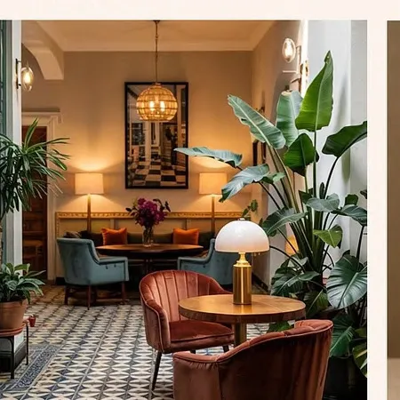 The first floor lounge, with soft seating, lamps and plants