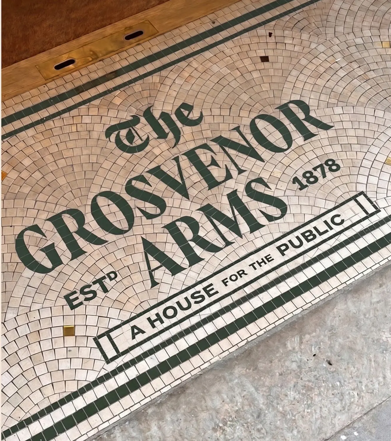 The mosaic threshold at the door, reading "The Grosvenor Arms, established 1878, a house for the public"
